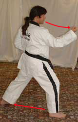 DSCF0036 10) Move left leg diagonally out and turn 90° to the right hip-twisting into a right walking stance towards A whilst performing a right middle block