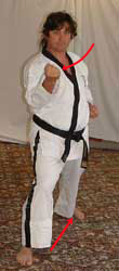 DSCF0040 12) Move left leg diagonally out and turn 90° to the right hip-twisting into a right walking stance towards C whilst performing a right middle block