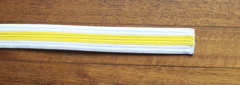 White with yellow tag belt