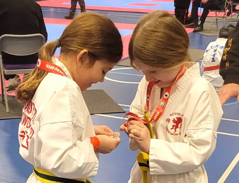 two girls with medals Two young girls proudly look at their medals